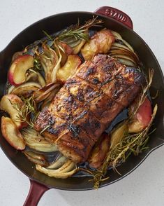 a pan filled with meat and vegetables on top of a table