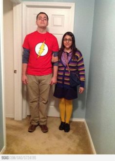 a man and woman standing in front of a door with the flash symbol on it