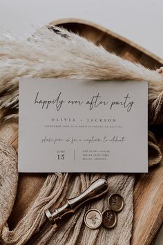 the wedding stationery is laid out on top of a fur - lined blanket and some keys