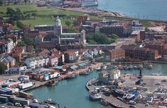 an aerial view of a harbor with boats docked in the water and buildings on both sides