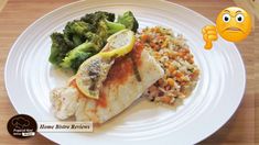 a white plate topped with fish, rice and broccoli on top of a wooden table