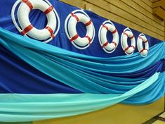 an inflatable sign that says cool on the side of a boat with life preservers attached to it