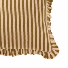 a brown and white striped pillow with tassels on the edges, against a white background