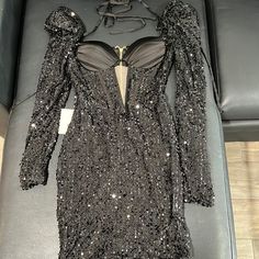 a dress with sequins on it sitting on a table