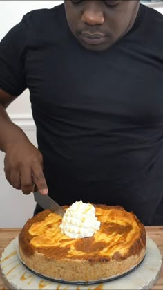 a man cutting into a pie with a knife