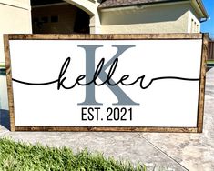 a wooden sign that says,'kelle est 2021'in front of a house