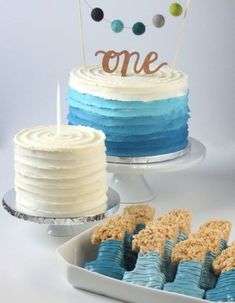 there are two cakes on the table and one is blue