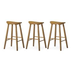 three wooden stools sitting next to each other