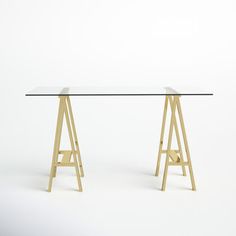 a glass table with two wooden legs and a metal base, against a white background