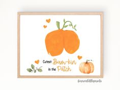 an orange pumpkin with leaves and hearts on it is in front of a white wall