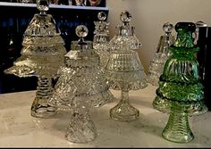 an assortment of glass vases sitting on top of a counter