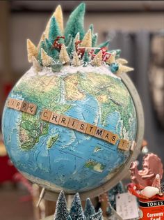 a christmas globe with the word merry christmas spelled on it