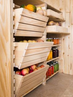 the shelves are filled with jars and fruit