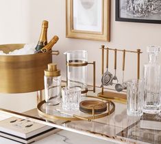 a glass table topped with bottles and glasses