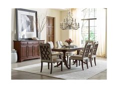 a dining room table with chairs and a chandelier