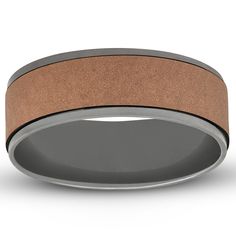 a wedding band that has been made in grey and tan sand with a black center