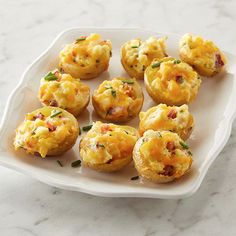 small muffins with cheese and bacon on a white plate