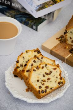 three pieces of cake on a plate next to a cup of coffee and books,