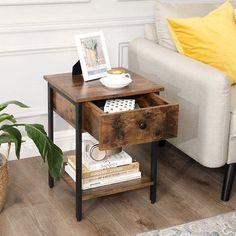 a small wooden table with a drawer on the bottom and some books in front of it