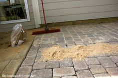 an image of a brick patio being cleaned with a mop and dust on the ground