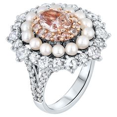 Presenting an exquisite Victorian-style Cocktail ring showcasing a mesmerizing 1.42 Carat Fancy Pink Brown Diamond in an oval shape, GIA Certified with VS1 clarity and Even color distribution. This stunning masterpiece embodies unrivaled beauty and sophistication. The central diamond is elegantly encircled by round brilliant pink diamonds and pearls, adding a touch of refinement. Additionally, it is adorned with 34 round brilliant white Diamonds totaling approximately 1.48 carats, complemented by 32 round brilliant diamonds totaling approximately 0.41 carats. Crafted with precision in a polished 18k Pink gold & 18k white gold mounting, this ring symbolizes true luxury. The total diamond weight is 3.31 carats, making this cocktail ring a statement piece of timeless charm and opulence. This Ring With Pearls, Diamonds And Pearls, Pink Diamonds, Diamond Cocktail Ring, Diamond Cocktail Rings, Fancy Color Diamonds, Brown Diamond, Pink Diamond, White Diamonds