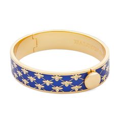 See what all the buzz is about with the Bee Sparkle Trellis Bangle from Halcyon Days. Crafted from brass and plated in 18ct gold, this 13mm hinged enamel bangle features trellis design with simple honey bee silhouettes on a deep cobalt enamel base. Delicate glass crystals have been added to each bee to create an elegant yet eye catching finish. This piece is perfect for day to night accessorising or an ideal luxury gift for lovers of nature. Bee Silhouette, Plant Cages, Halcyon Days, Trellis Design, Enamel Bangle, The Bee, Gold Bangle, Hinged Bangle, For Lovers