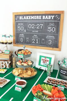 a football baby shower with snacks on the table