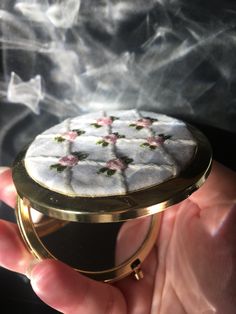 This exquisite hand-embroidered pocket mirror features an elegant gold exterior, adorned with intricate embroidery for a touch of timeless beauty. Its compact design opens to reveal two mirrors inside, making it both stylish and practical for on-the-go touch-ups. Perfect for adding a touch of luxury to your everyday routine or as a thoughtful gift for someone special. Mirror For Makeup, Mirrors For Makeup, Mirror Compact, Embroidered Pocket, Makeup Travel, Everyday Routine, Cosmetic Mirror, Intricate Embroidery, Pocket Mirror