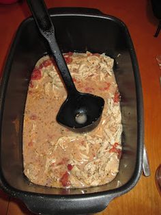 a pan filled with food on top of a wooden table