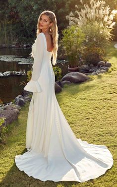 ALYSSA is a fit-n-flare gown in ivory Crepe with slit, ivory Chiffon bell sleeves, and buttons to the end of the train. Wedding Long Sleeve Dress, Long Sleeve Wedding Gowns, Wedding Gowns With Sleeves, Flare Gown, Fit And Flare Wedding Dress, Minimal Wedding