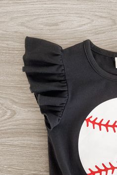 Perfect for warm weather wear Top features ruffle sleeves with a tie waist & a baseball on the front Shorts feature stretch waist & an allover striped print Top and shorts pair for versatility & ease Your little one is going to be the cutest at the ballpark in our Black Striped Baseball Denim Short Set for girls. The black short sleeve top features a fun baseball design on the front and looks adorable paired with the denim shorts. The stretch waistband helps comfort and fit and can be great for Baseball Design, Weather Wear, Spandex Shorts, Denim Short, Red Stripe, Ruffle Sleeves, Red And White Stripes, Short Set, Print Top