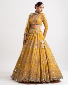 Intricately hand embroidered with thread zari and sequins sweetheart blouse, lehenga and a heavy mirror cut work net dupatta.From Vvani Vats Rang's collection.DELIVERY TIMEPlease allow 8-12 weeks for your outfit to arrive.FABRIC DETAILSNet, Georgette, Silk BlendProfessional cleaning only. Multi Color Lehenga, Sweetheart Blouse, Blouse Lehenga, Lehenga Dupatta, Zipper Blouse, Yellow Lehenga, Net Blouses, Georgette Dupatta, Lehenga Skirt