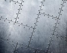 an abstract metal background with rivets and screw holes in the center is shown