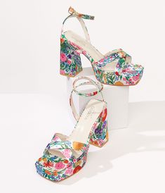 These charming platform sandals feature a floral print on a classic white background, perfect for adding a touch of flower power to any outfit. The satin-like material and crisscross upper design give these platforms a unique and stylish look that will have you standing out from the crowd. With an adjustable ankle strap for the perfect fit, these sandals are as comfortable as they are cute. Complete with a 1.25 inch platform and 4.25 inch heel.Available while supplies last. Patterned Heels, Pink Floral Heels, Funky Heels, Homecoming Shoes, Yellow Heels