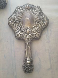 an ornate metal object on a white surface