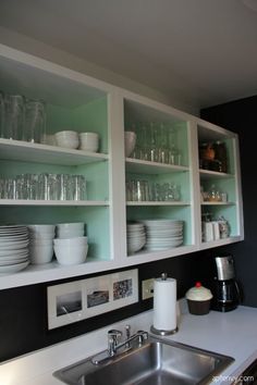 the shelves are filled with glassware and jars for dishes to be stored on them