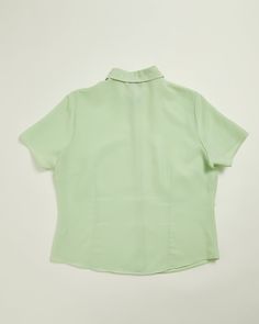 Elevate your style with this vintage Apple Green shirt from BHS. This shirt exudes simplicity and effortless style. Simple to throw over shorts or under a jumper! A great timeless piece. Material : 100% Polyester Measurements : Armpit to Armpit 21.5 inchs /55cms . Nape of neck to bottom to hem 24ins /61cms UK SIZE 14 Trees planted 1 Classic Plain Summer Blouse, Retro Green Top For Daywear, Classic Plain Blouse For Summer, Classic Green Tops For Daywear, Classic Green Top For Daywear, Classic Green Summer Blouse, Green Tops With Relaxed Fit And Collar, Green Collared Top For Daywear, Retro Short Sleeve Tops For Workwear