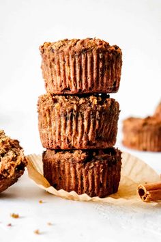 three muffins stacked on top of each other with cinnamon sticks next to them