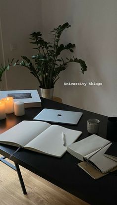 an open book sitting on top of a table next to a candle