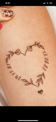 a woman's thigh with a heart shaped tattoo on it