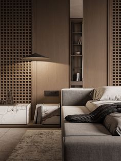 a bed sitting in the middle of a living room next to a lamp and book shelf