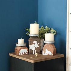 three candles sitting on top of a wooden table