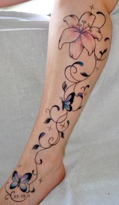 a woman's foot with a flower and butterfly tattoo design on the left side of her leg