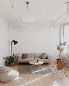 a living room with white walls and wooden floors