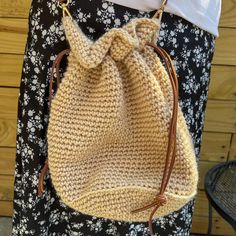 The Crochet Bucket Bag is made by hand with fashionable leather drawstring cords and leather strap. Perfect for accessorizing an outfit and for those who love neutral colors.  If you have any questions, don't hesitate to reach out! I'd be glad to make you a custom order.  Washing Instrutions:  Wash in washing machine on cold or hand wash, then lay flat to air dry. May need to flip over to ensure even dry time. Never put in the dryer; it could cause shrinking and fraying. Shipping Information: Only takes 1-2 weeks to create and ship this handmade product. Shipping time is 2-5 days in the United States. Thanks for visiting! Handmade Cream Bucket Bag For Everyday, Crochet Bucket Bag For Everyday Use, Handmade Hobo Bucket Bag For Everyday Use, Beige Crochet Bucket Bag For Everyday, Drawstring Bag Crochet, Crochet Bucket Bag, Leather Strap Bag, Crochet Bucket, Strap Bag