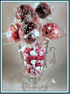 a glass mug filled with chocolate covered donuts and sprinkles on top