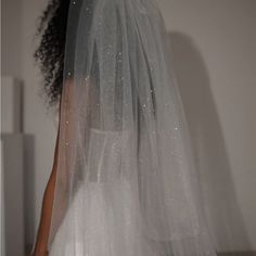 the back of a bride's wedding dress with white sequins on it