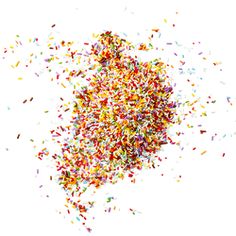 multicolored confetti sprinkles on white background