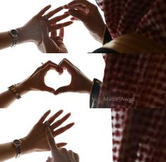 several hands making a heart shape with their fingers in the middle and on each other