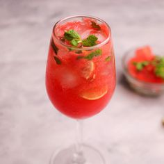 a glass filled with watermelon and mint garnish